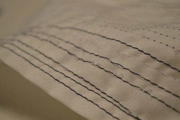 The black thread is the bobbin thread and the white is the needle thread.